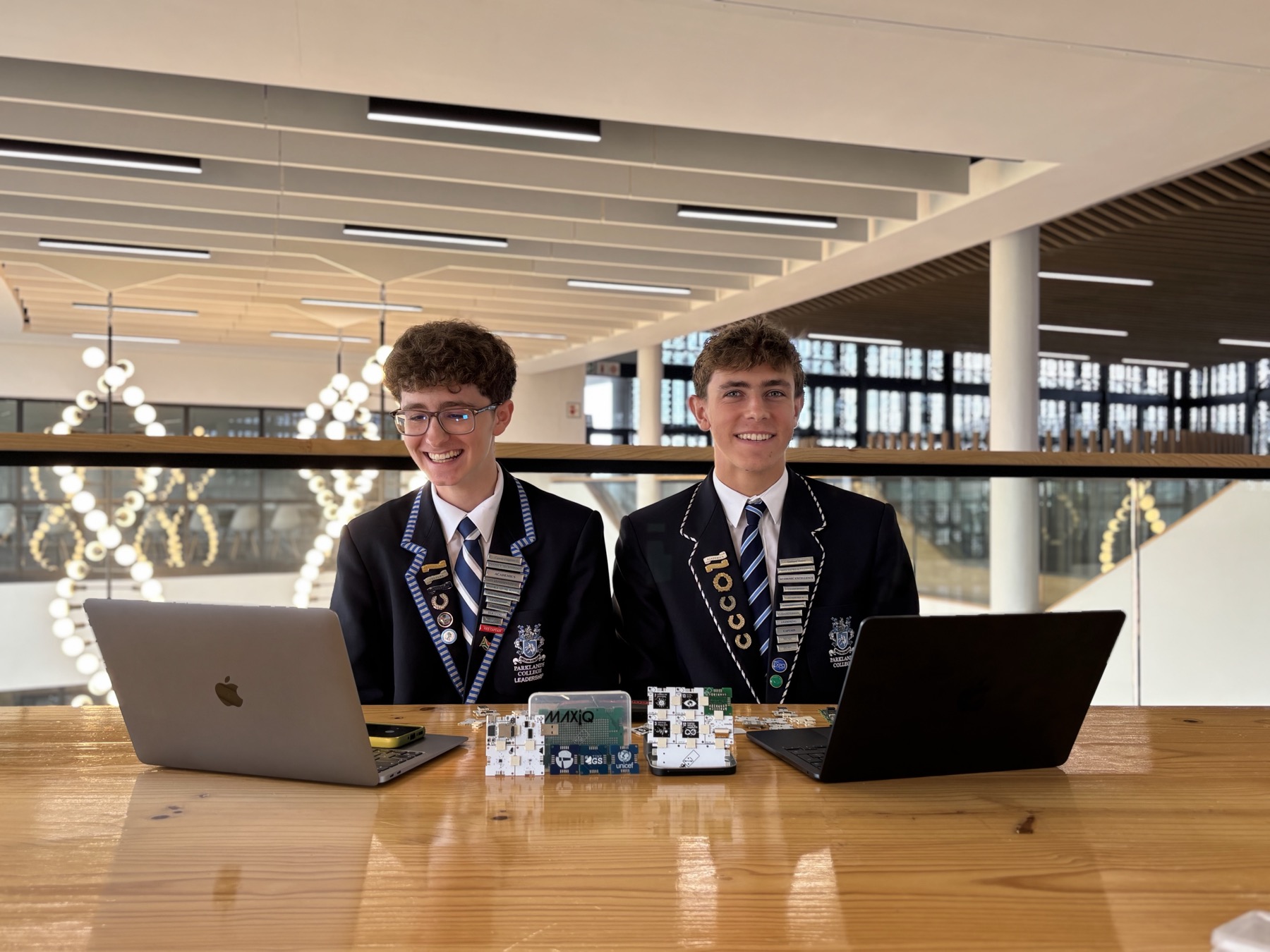 Students with laptops and a 3D-printed CubeSat model